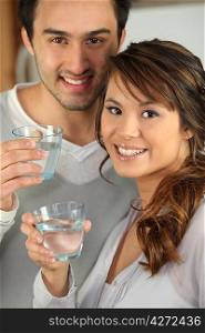 Couple drinking glasses of water