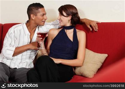 Couple drinking on sofa