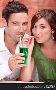 Couple drinking the same cocktail