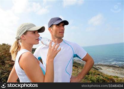 Couple drinking water after exercising