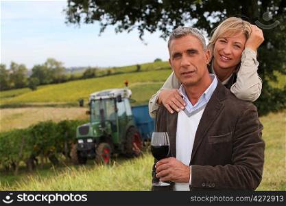 Couple drinking wine in a vineyard