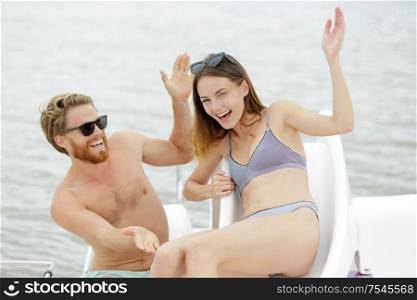couple driving a pedal boat on a vacation