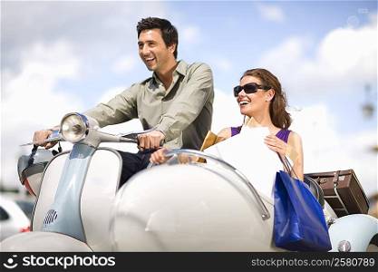 Couple driving a scooter