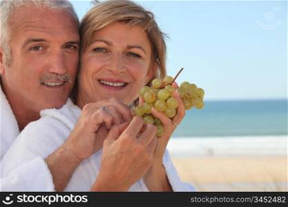 Couple eating a bunch of grapes