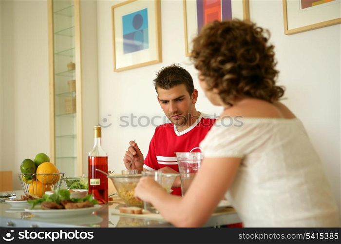 Couple eating a meal together at home