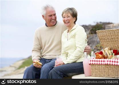 Couple Eating An Al Fresco Meal At The Beach