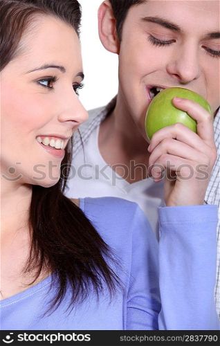 Couple eating an apple