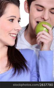 Couple eating an apple