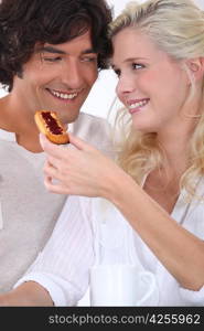 Couple eating biscuit&acute;s for breakfast