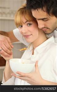 Couple eating bowl of cereal