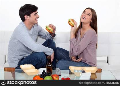 Couple eating hamburgers