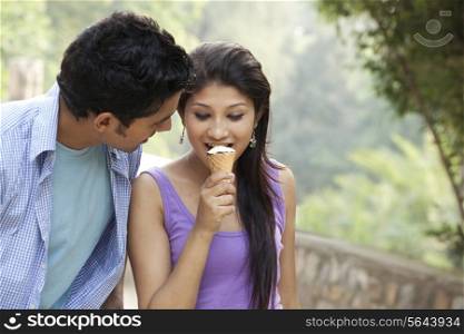 Couple eating ice cream in lawn