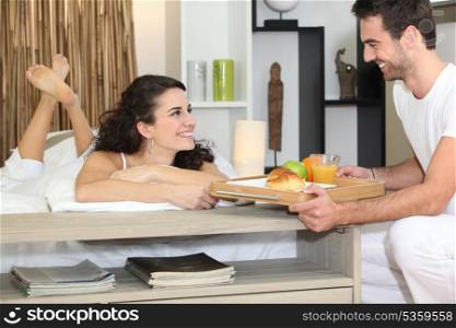 Couple eating in bed