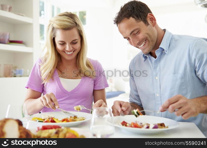 Couple Eating Meal At Home Together