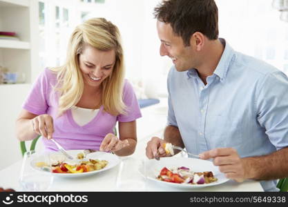 Couple Eating Meal At Home Together