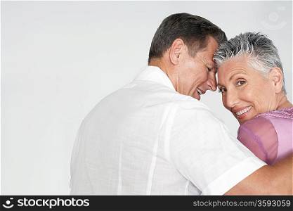 Couple embracing against white background portrait