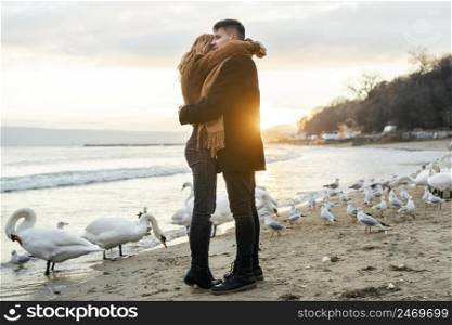 couple embracing beach winter