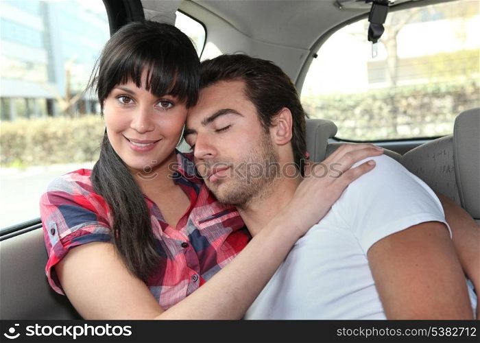 Couple embracing in car