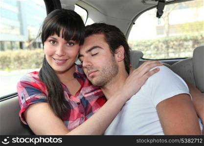 Couple embracing in car