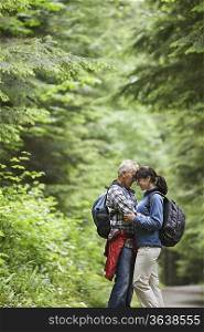 Couple embracing in forest, side view
