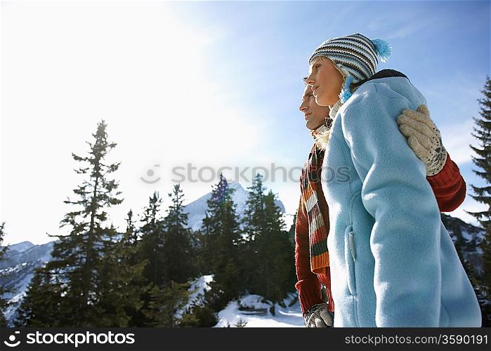 Couple embracing in mountains side view low angle view