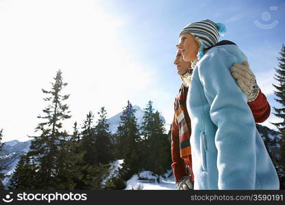 Couple embracing in mountains side view low angle view