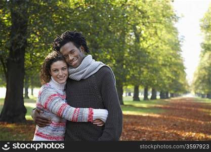 Couple embracing in park