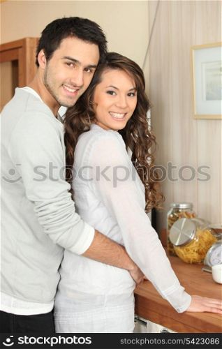 couple embracing in the kitchen