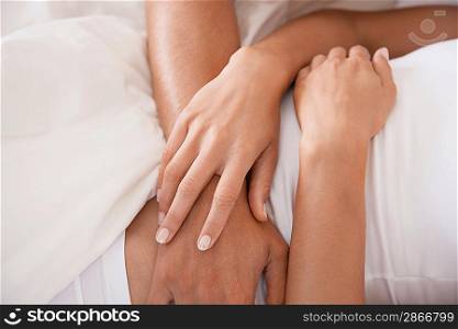 Couple embracing lying down mid section