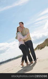 Couple embracing on beach