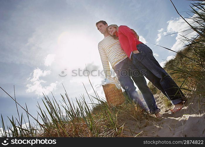 Couple embracing on sand dune