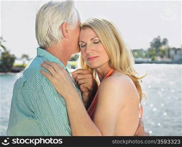 Couple embracing standing by river