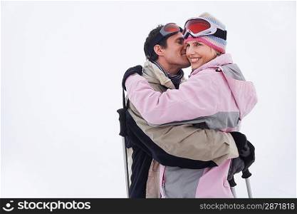 Couple embracing standing in snow