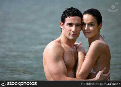 Couple embracing while bathing in the sea