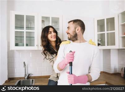 couple embracing while cleaning