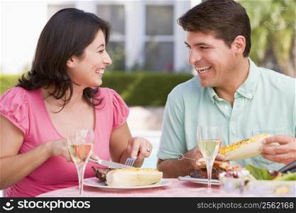 Couple Enjoying A Barbequed Meal In The Garden
