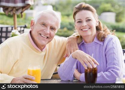 Couple Enjoying A Beverage By A Golf Course