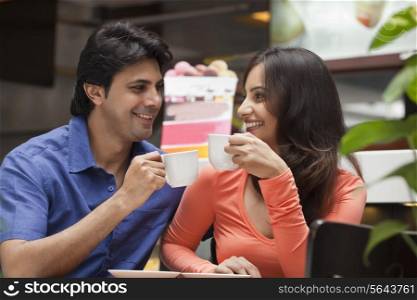 Couple enjoying a cup of tea in shopping mall