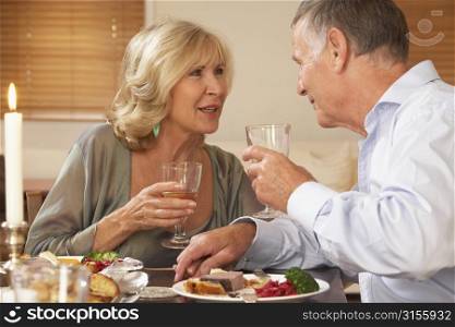 Couple Enjoying A Meal At Home Together