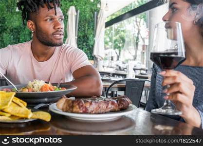 Couple enjoying and spending good time together while having a date at a restaurant.