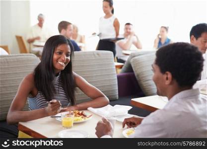 Couple Enjoying Breakfast In Hotel Restaurant