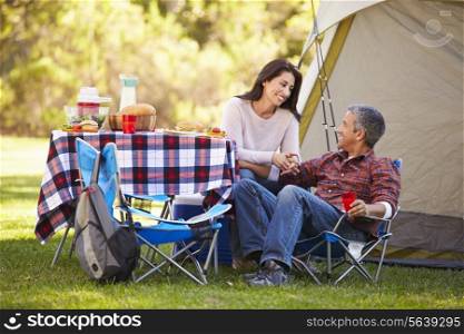 Couple Enjoying Camping Holiday In Countryside