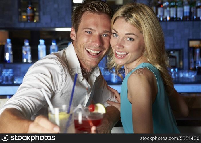 Couple Enjoying Cocktail In Bar