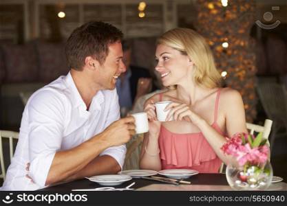 Couple Enjoying Cup Of Coffee In Restaurant