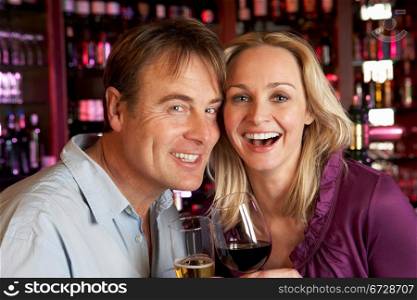 Couple Enjoying Drink Together In Bar