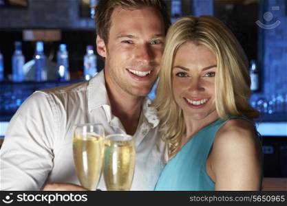 Couple Enjoying Glass Of Champagne In Bar