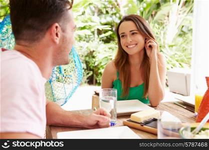 Couple Enjoying Meal Outdoors At Home