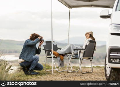 couple enjoying nature while road trip with car camera