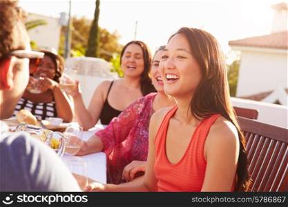 Couple Enjoying Outdoor Summer Meal With Friends