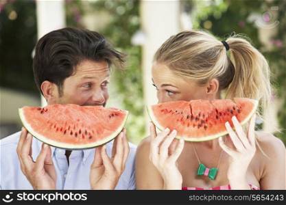 Couple Enjoying Slices Of Water Melon